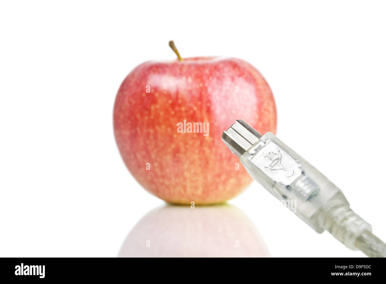 Apple with Firewirekabel Apple firewire cable Stock Photo