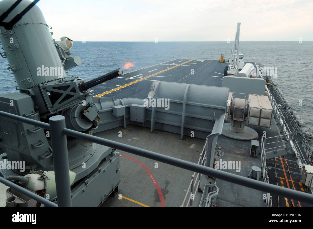 A close-in weapons system fires aboard USS Kearsarge. Stock Photo