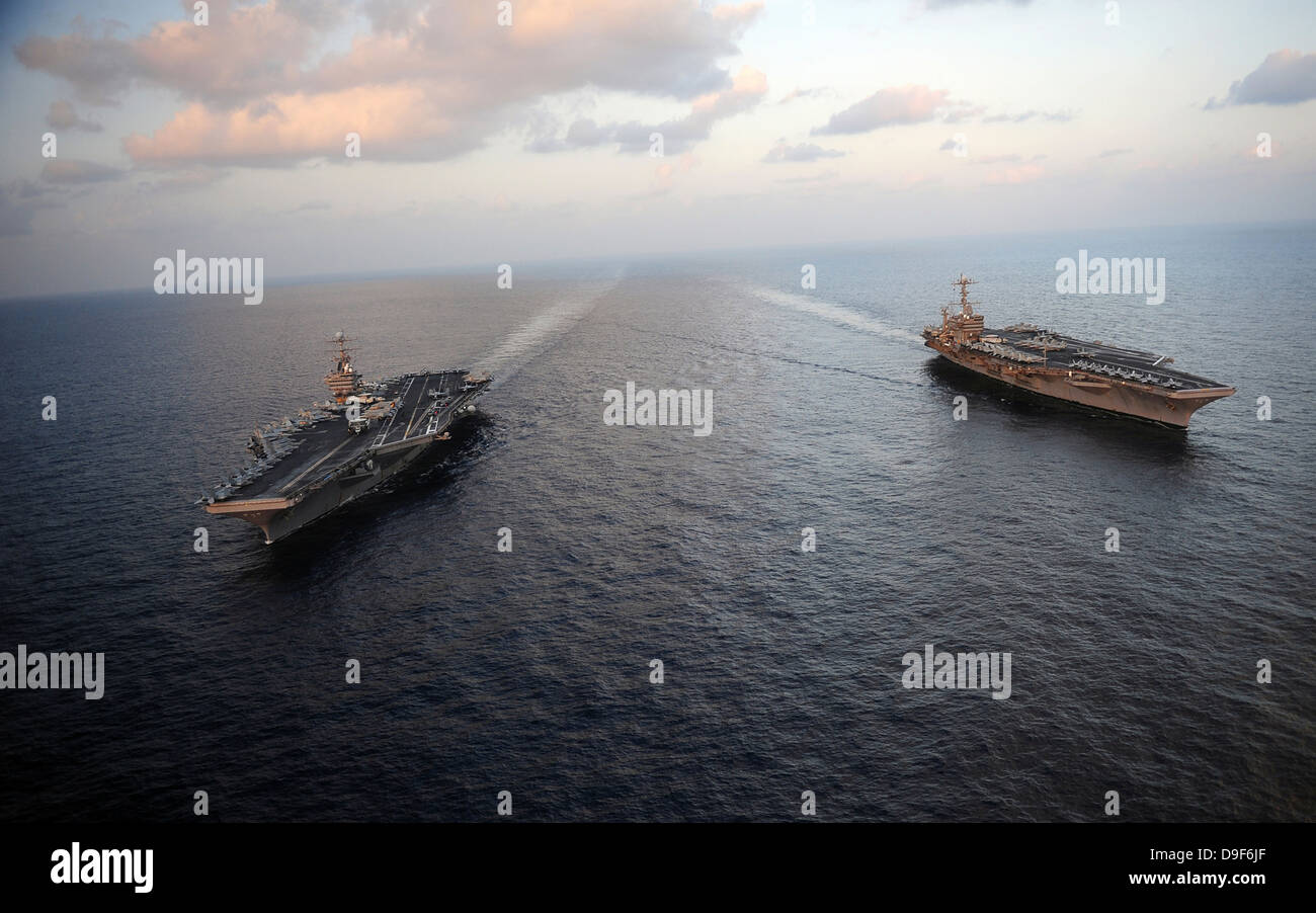 Nimitz-class aircraft carriers transit the Arabian Sea. Stock Photo