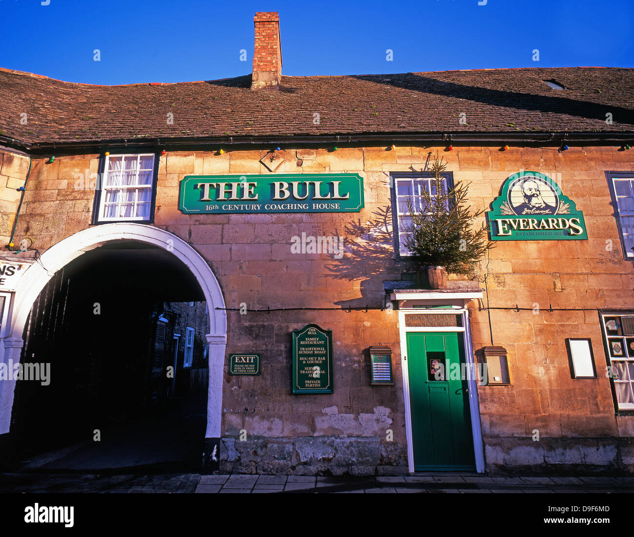 The Bull - warm morning light on a 16th century stone built pub / restaurant in the market town of Market Deeping, Lincolnshire, England, UK. Stock Photo