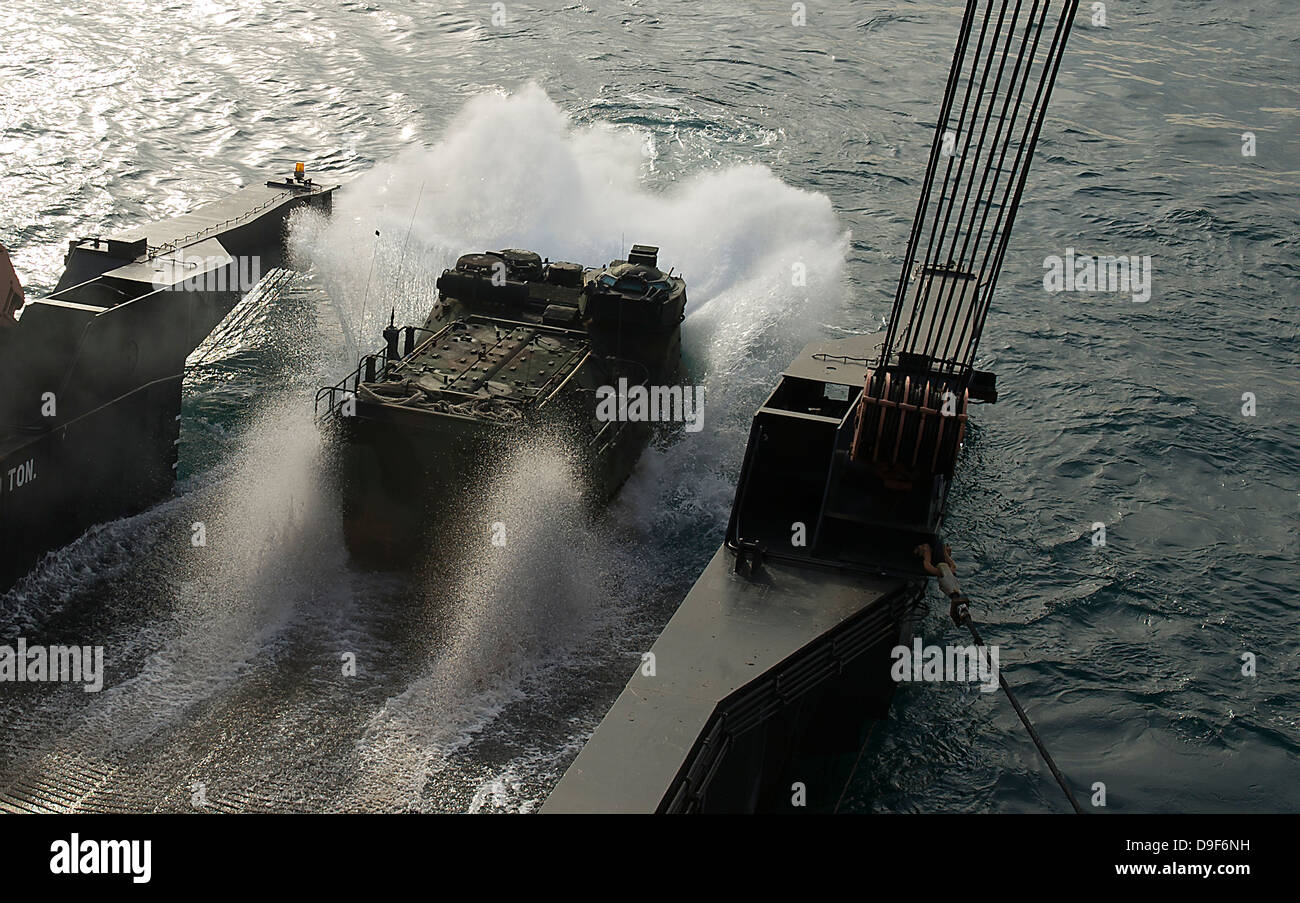 An amphibious assault vehicle debarks from a Military Sealift Command ship. Stock Photo