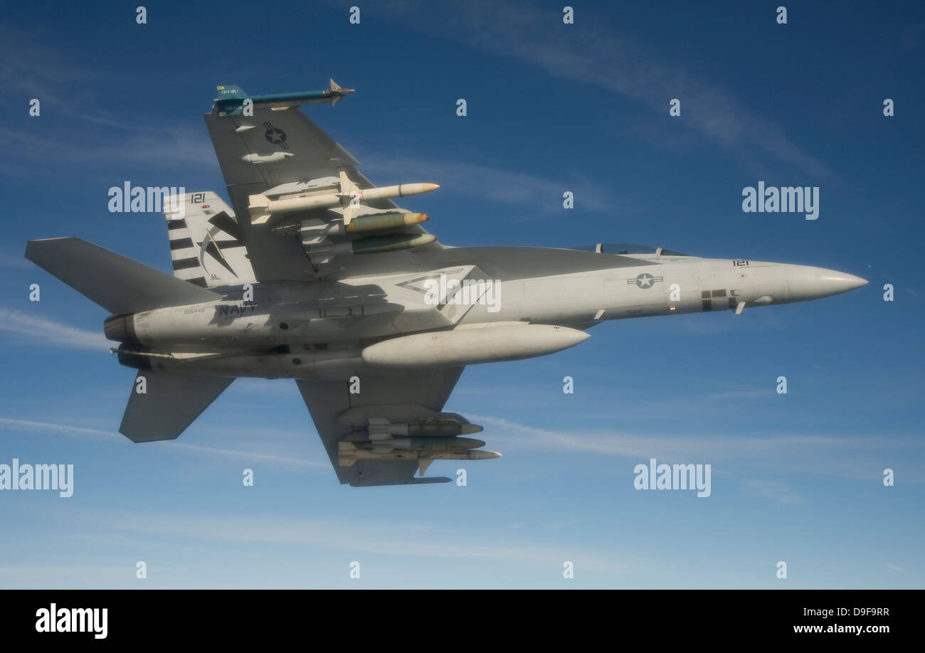 An F/A-18F Super Hornet conducts a captive carry flight test of an AGM-88E Advanced Anti-Radiation Guided Missile. Stock Photo