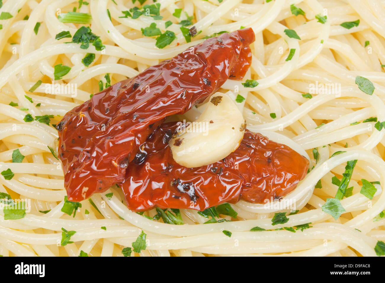 Spaghetti with inlaid tomatoes and garlic spaghetti with marinated tomatoes and garlic Stock Photo