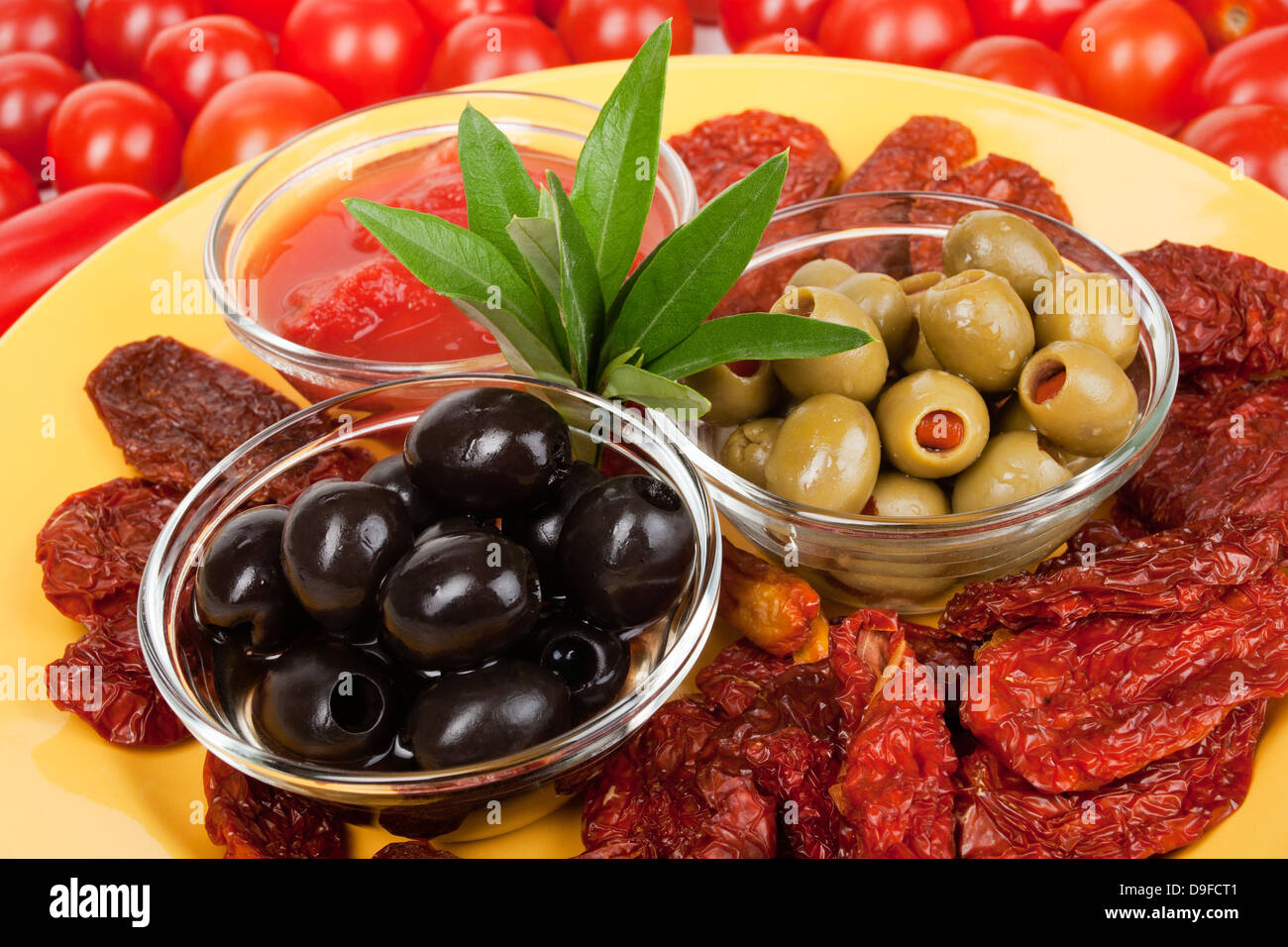 Olives with passed tomatoes and dry tomatoes of olive with tomato cream and dried tomatoes Stock Photo