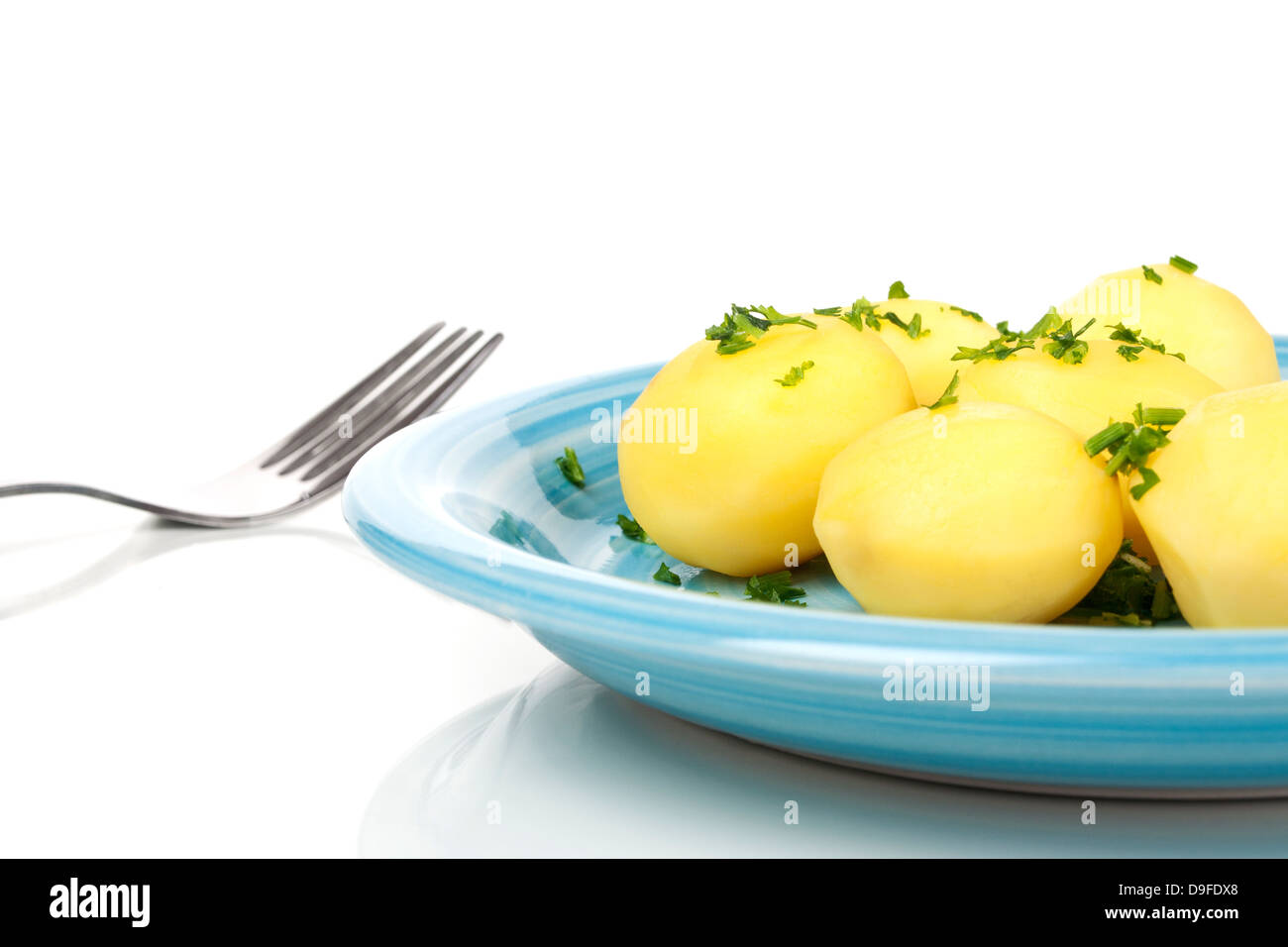 Plate with boiled potatoes and parsley Plate with boiled potatoes and parsley Stock Photo