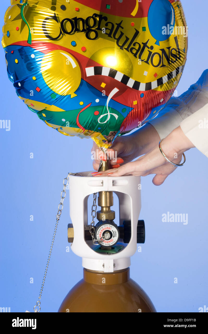 filling Helium party balloons from cylinders Stock Photo Alamy