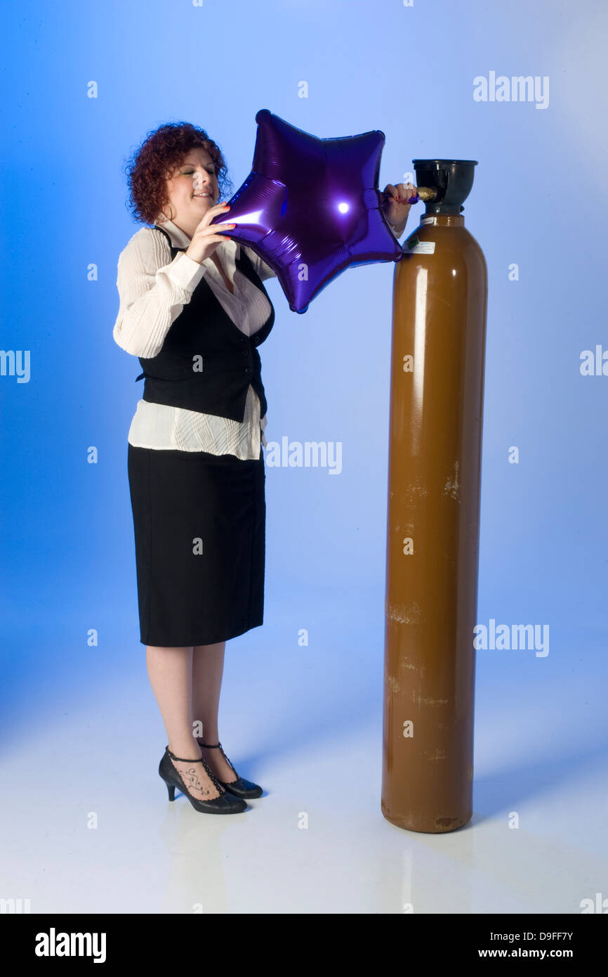 filling Helium party balloons from cylinders Stock Photo Alamy