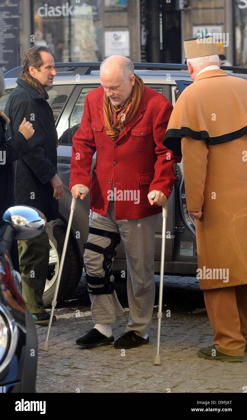 John Malkovich arrives at his hotel in Warsaw on crutches with his right leg strapped up. Warsaw