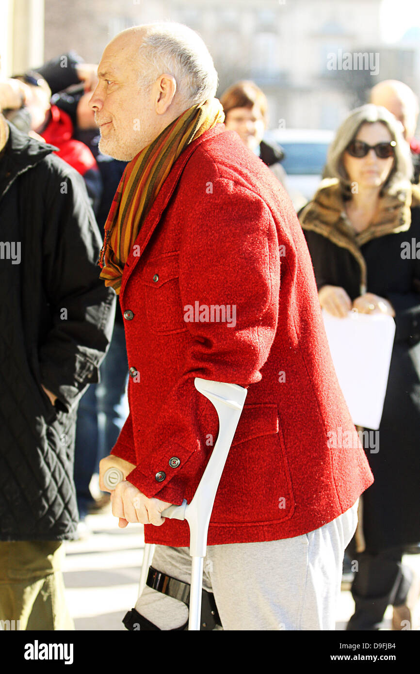 John Malkovich arrives at his hotel in Warsaw on crutches with his right leg strapped up. Warsaw