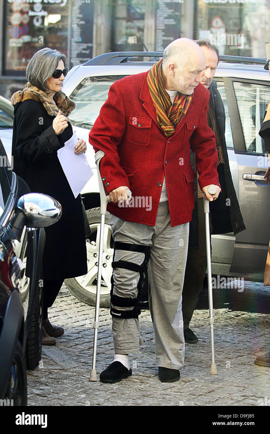 John Malkovich arrives at his hotel in Warsaw on crutches with his right leg strapped up. Warsaw