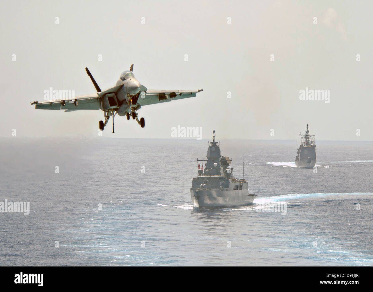 A US Navy F/A-18F Super Hornet approaches the flight deck of the aircraft carrier USS Dwight D. Eisenhower to land during operations June 14, 2013 in the Mediterranean Sea. Stock Photo