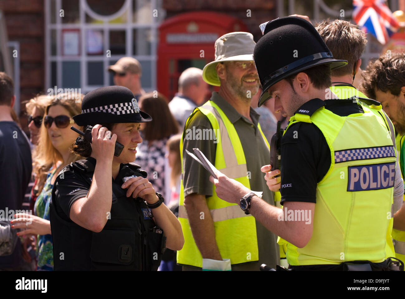 Police officers on duty in town square during Spring Festival, Petersfield, Hampshire, UK. Stock Photo