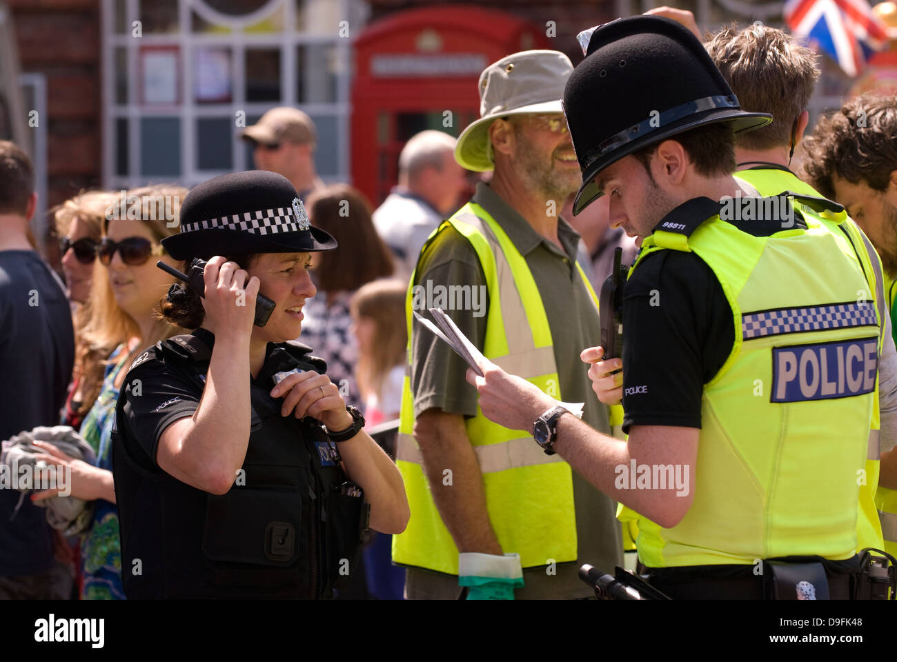 Police officers on duty in town square during Spring Festival, Petersfield, Hampshire, UK. Stock Photo