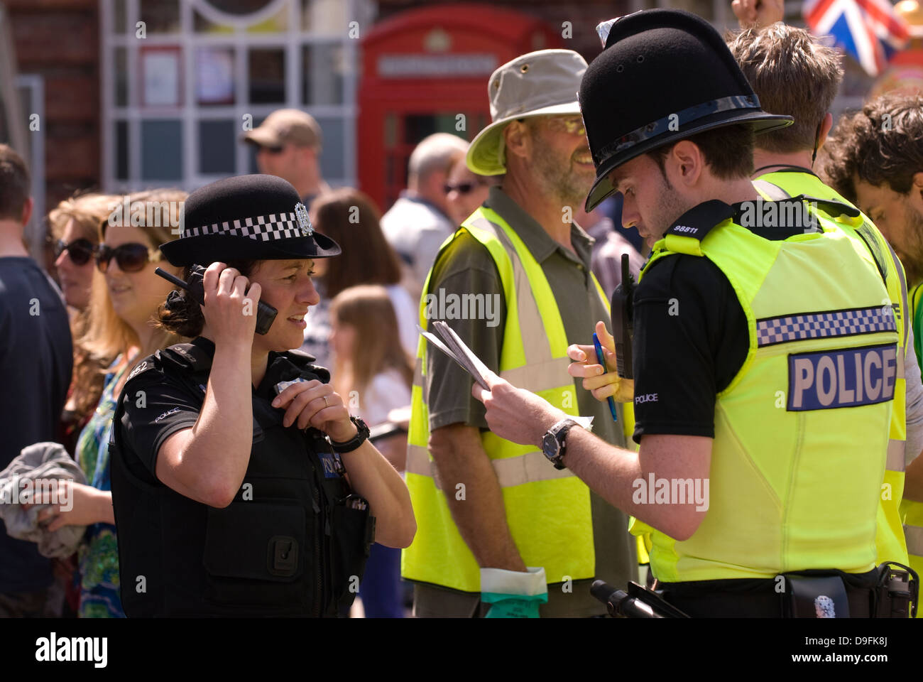 Police officers on duty in town square during Spring Festival, Petersfield, Hampshire, UK. Stock Photo