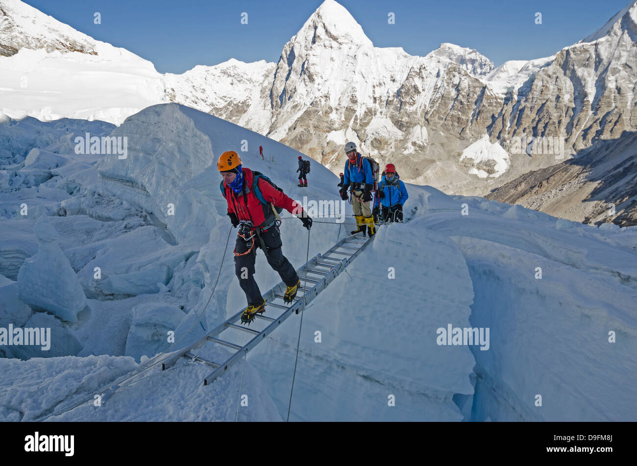 Crossing ladders in the Khumbu icefall on Mount Everest, Sagarmatha National Park, UNESCO World Heritage Site, Nepal, Himalayas Stock Photo