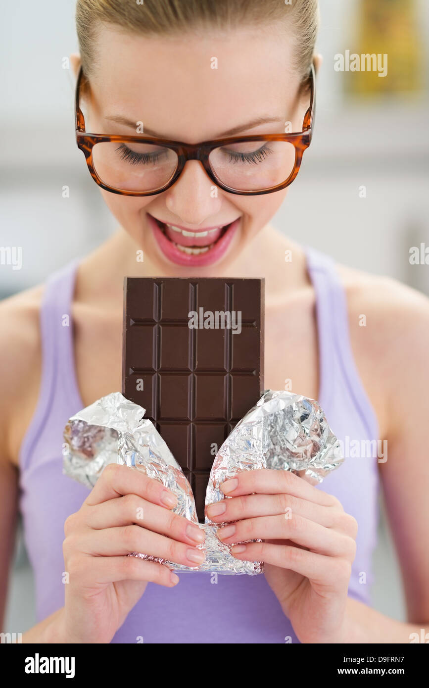 Teenage girl eating chocolate bar Stock Photo