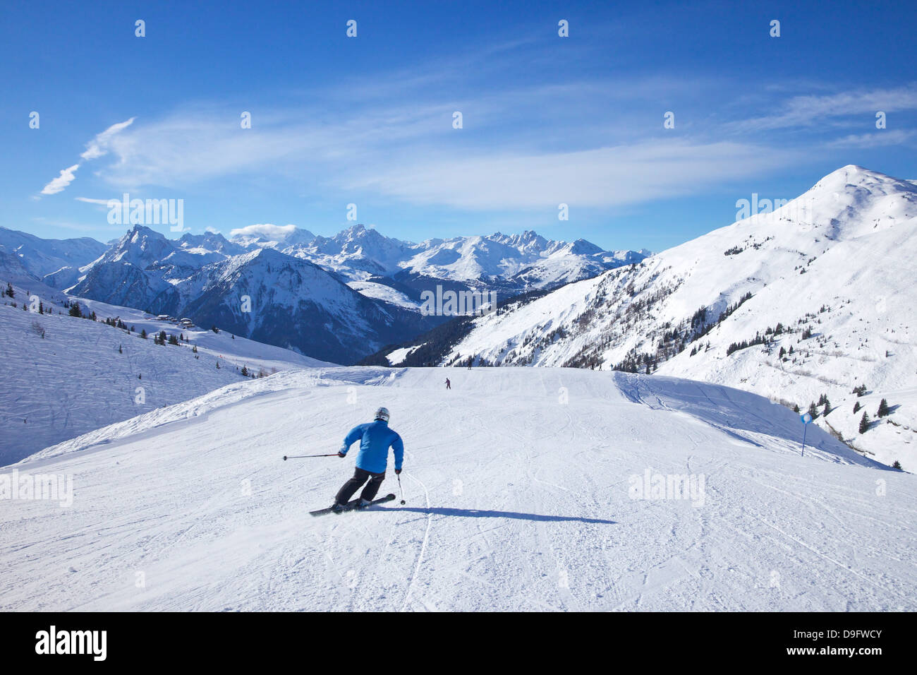 Skiers on Levasset blue piste in winter sunshine, Champagny, La Plagne, French Alps, France Stock Photo
