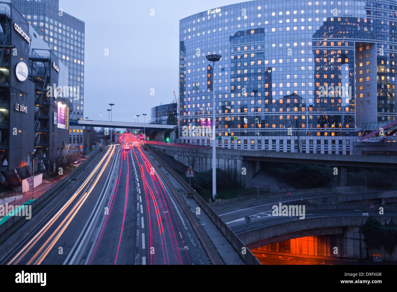 Evening traffic flowing through the La Defense area of Paris, France Stock Photo