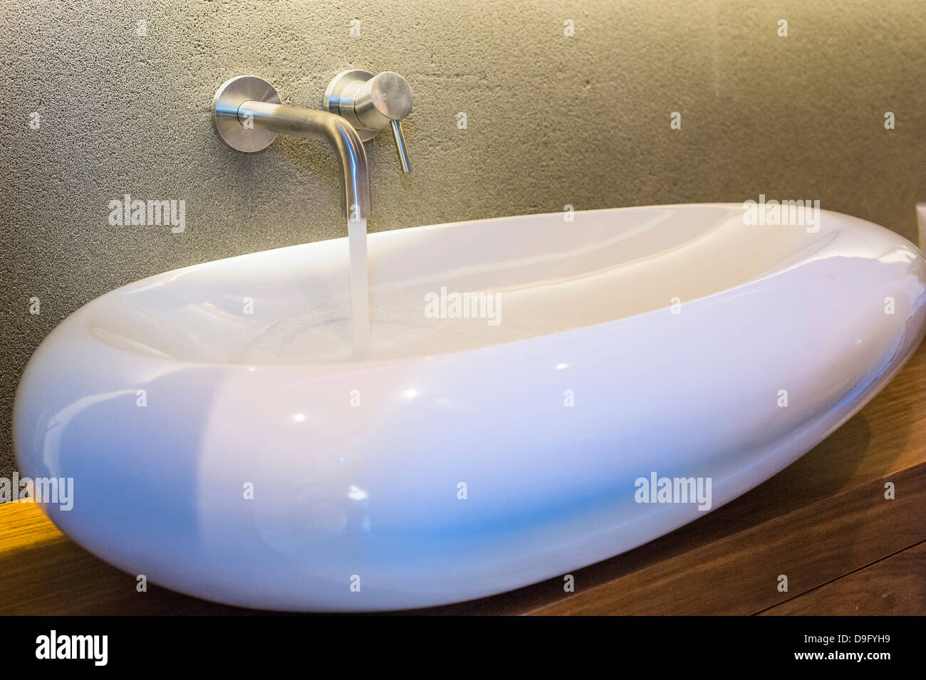 Bathroom sink with running water Stock Photo Alamy