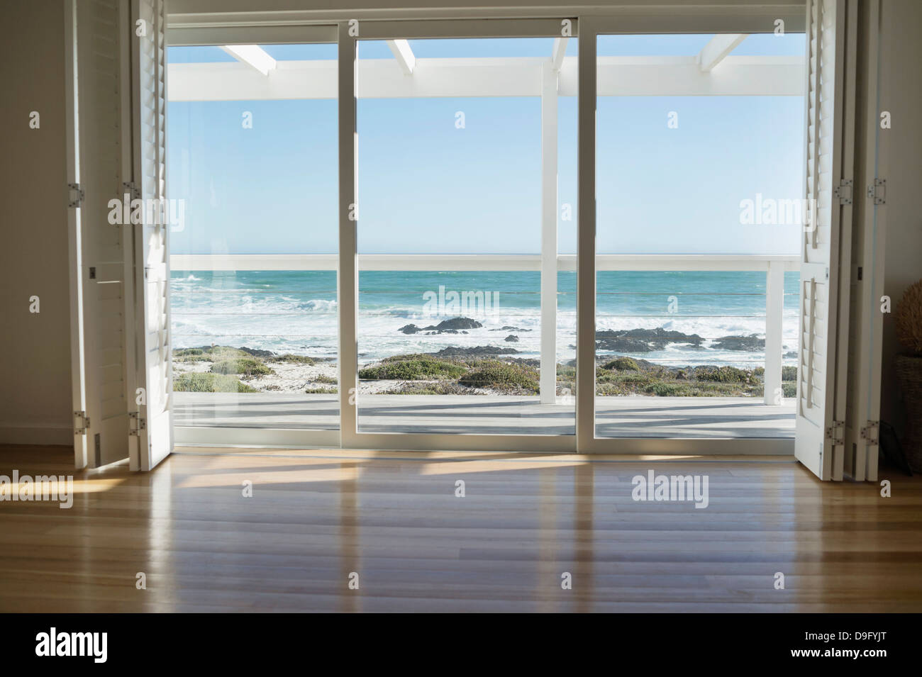 Sea viewed through from a glass door Stock Photo