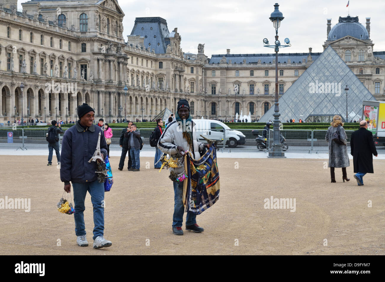 Street traders with goods for sale to tourists outside Musee du Louvre in Paris, France - Jan 2012 Stock Photo