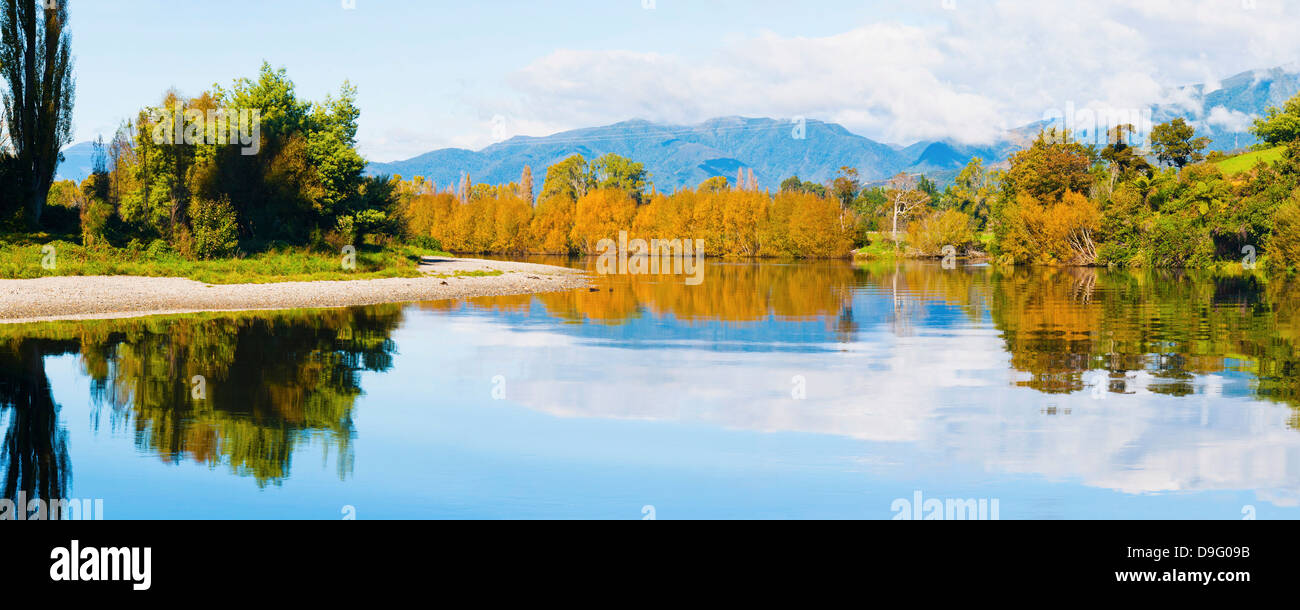 Reflection of autumn trees on the Takaka River, Golden Bay, Tasman Region, South Island, New Zealand Stock Photo