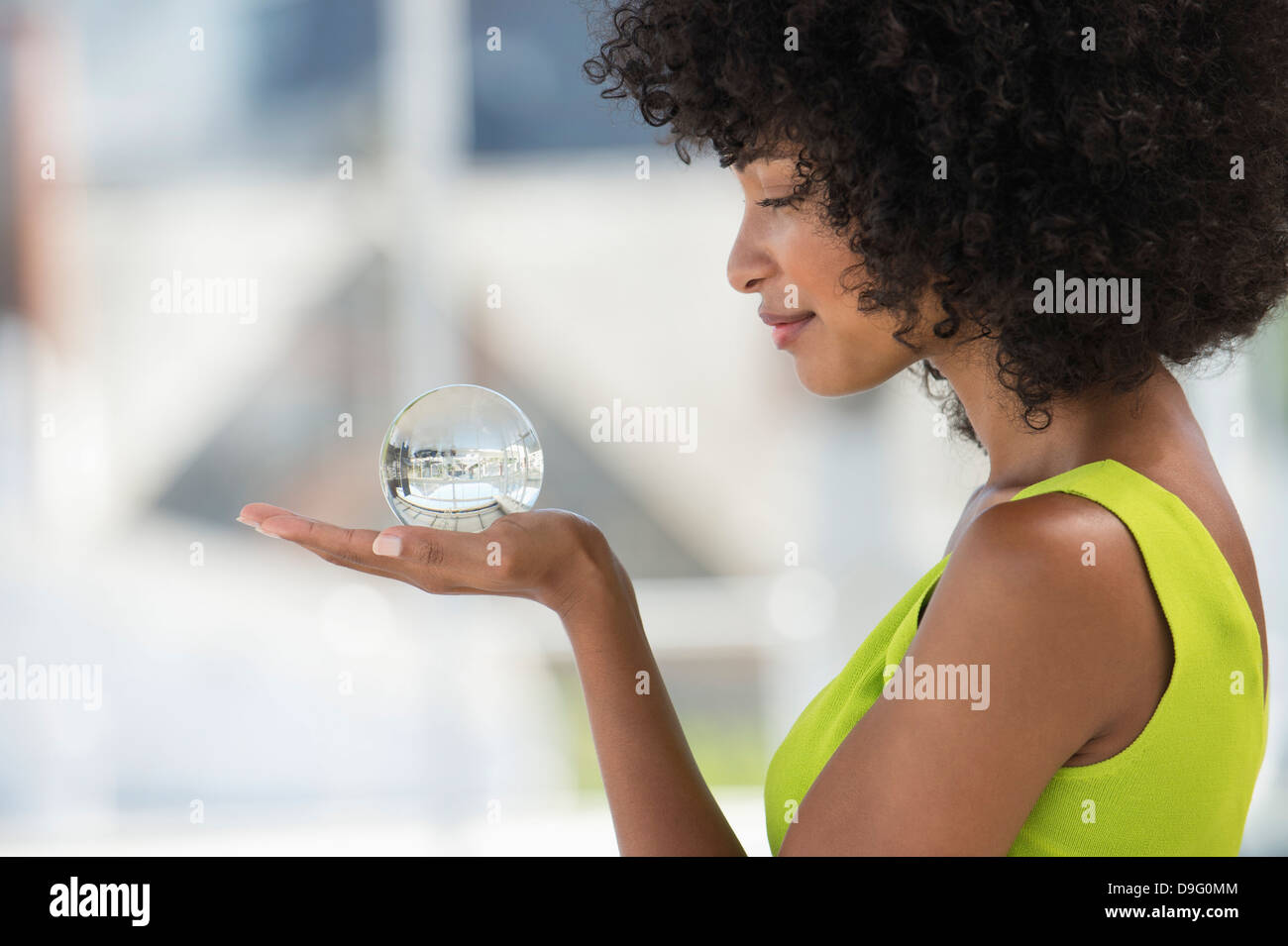 Close-up of a woman holding a crystal ball Stock Photo - Alamy