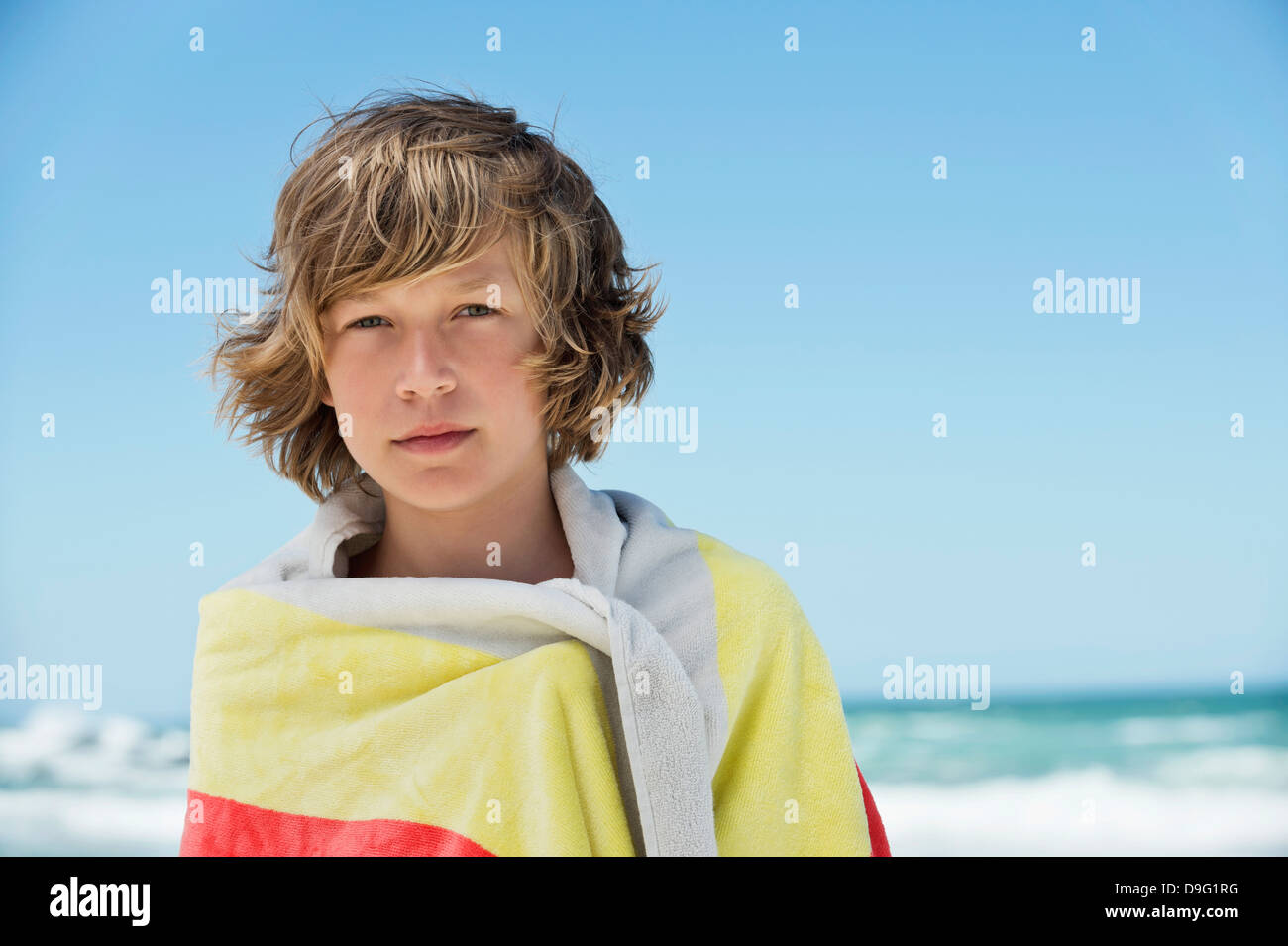 Portrait of a boy wrapped in a towel on the beach Stock Photo Alamy