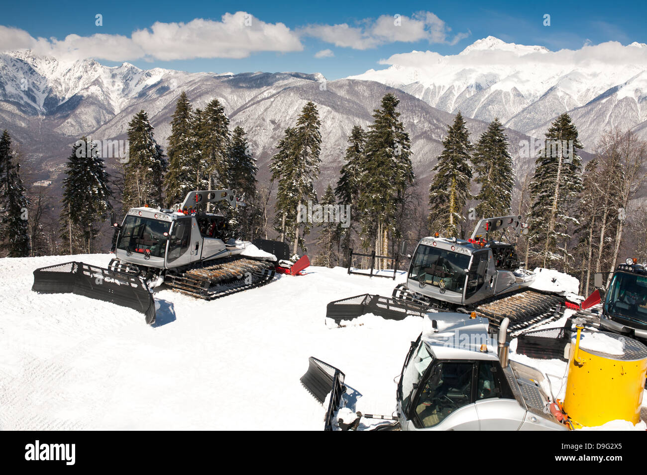 Snowplows, mountains on background Stock Photo