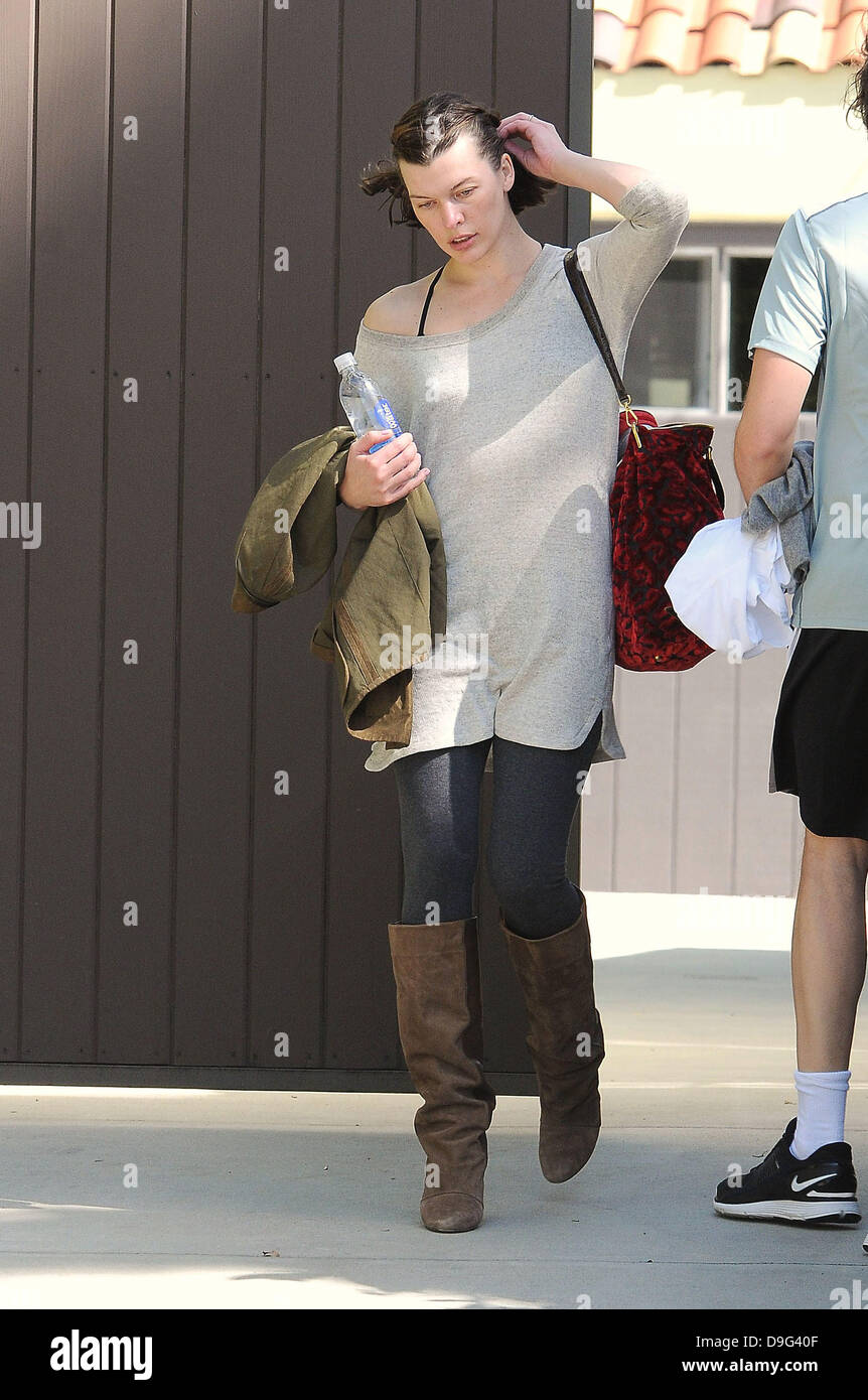 Milla Jovovich wearing brown knee length boots and t-shirt, leaving the gym  with her husband Paul W. S. Anderson Los Angeles, California - 08.03.11  Stock Photo - Alamy
