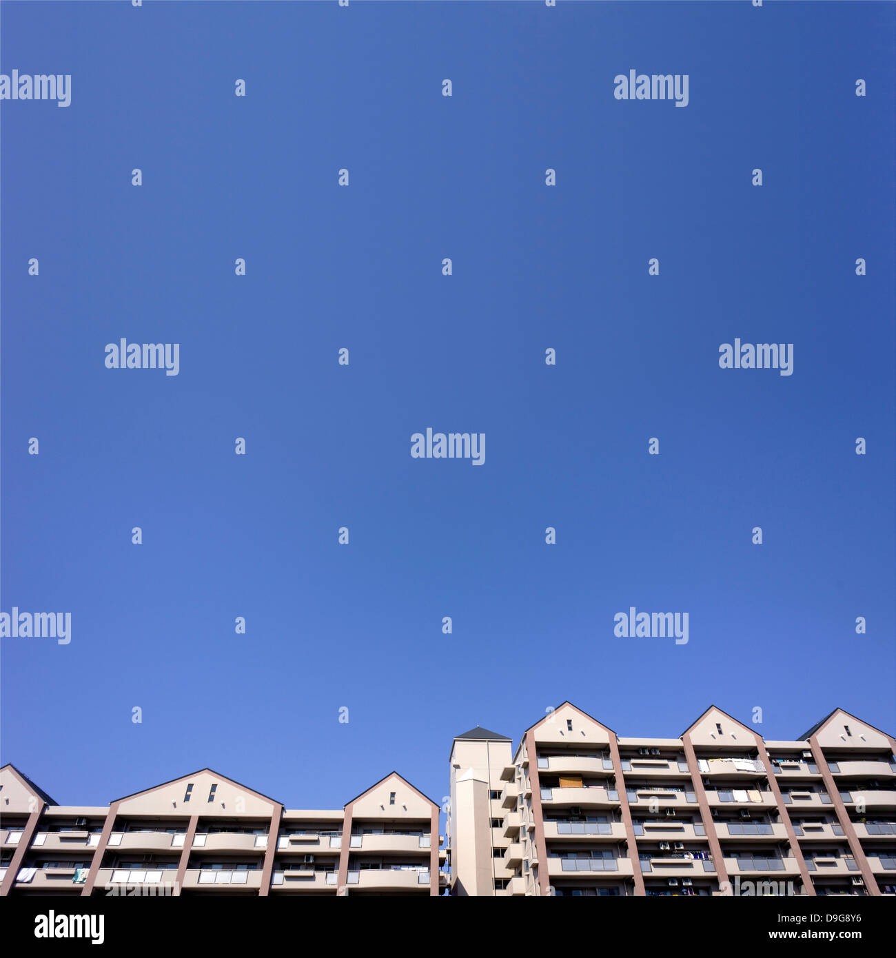 Apartment buildings and blue sky Stock Photo - Alamy
