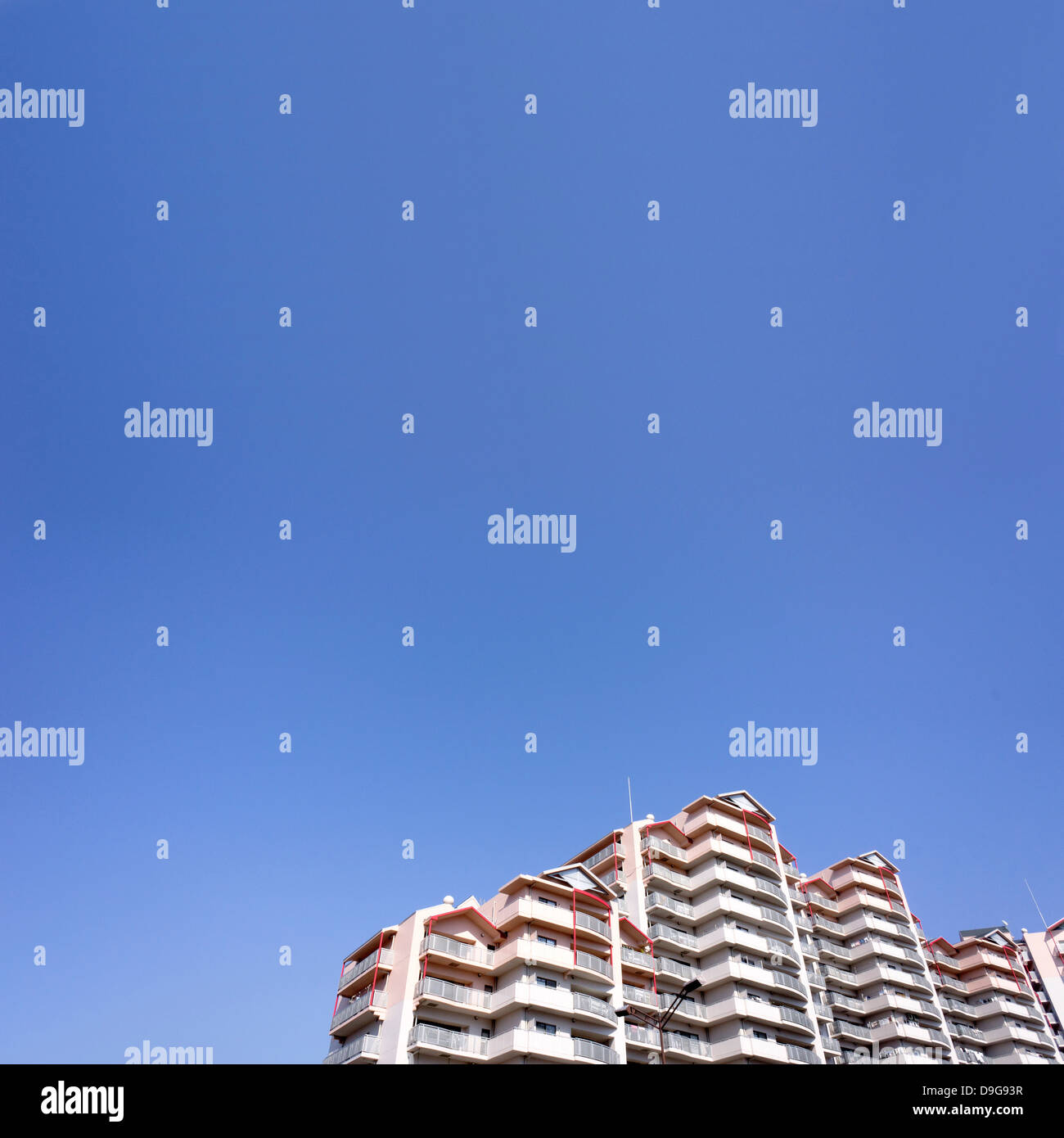Apartment building and blue sky Stock Photo - Alamy