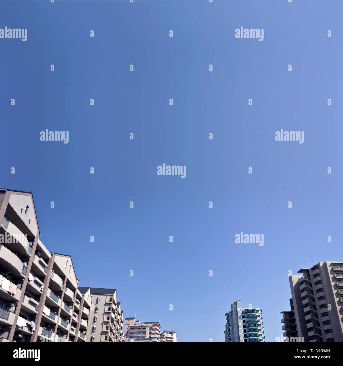 Apartment buildings and blue sky Stock Photo - Alamy