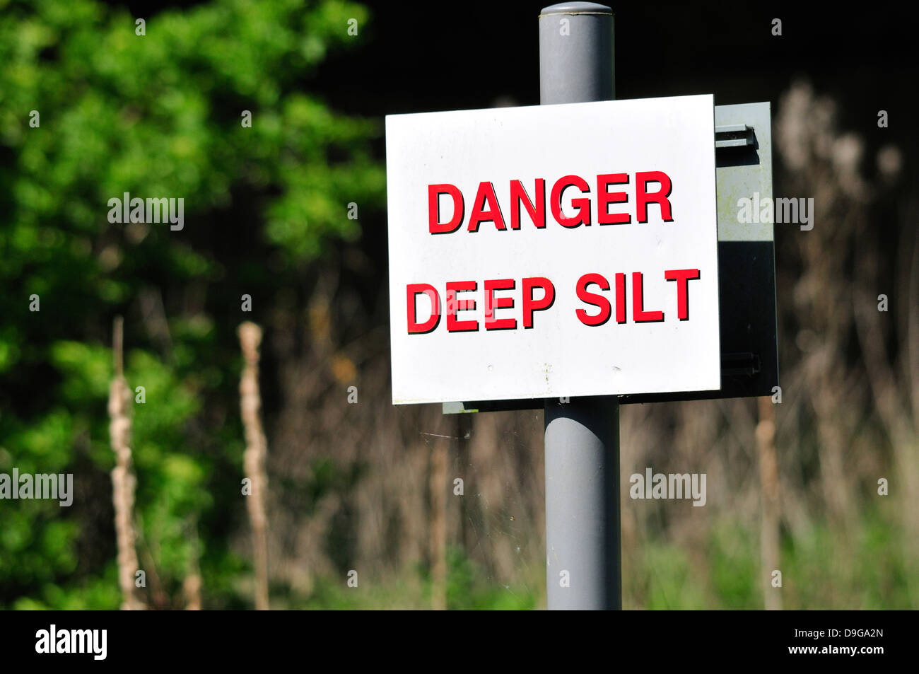 Warning sign by stream 'Danger, deep silt'. Loose Village, Kent, England. Stock Photo