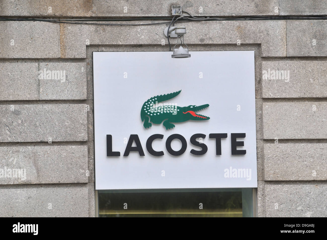 Lacoste logo sign crocodile on facade of store Braga Portugal Stock Photo