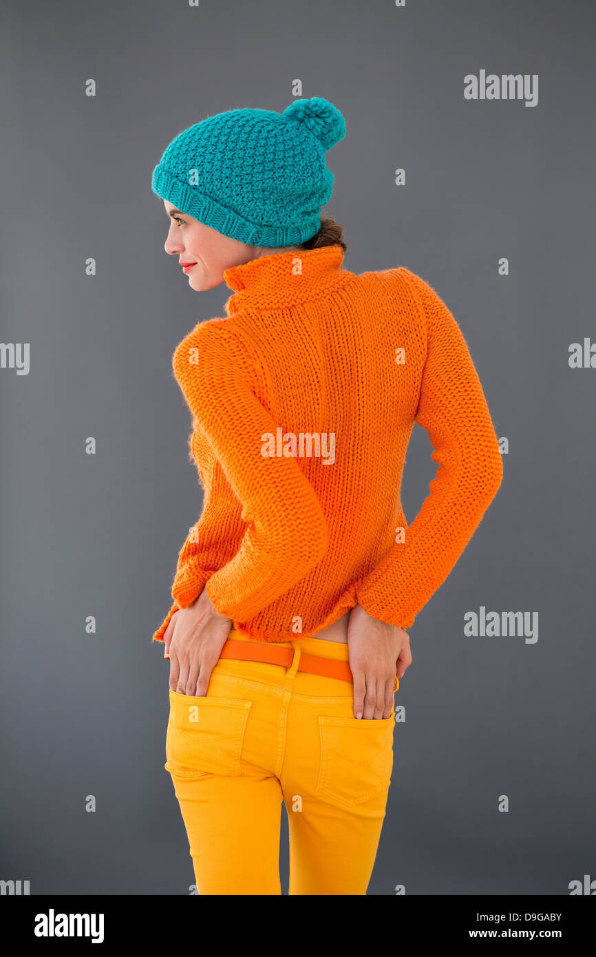 Rear view of a woman standing with her hands in her pockets Stock Photo ...