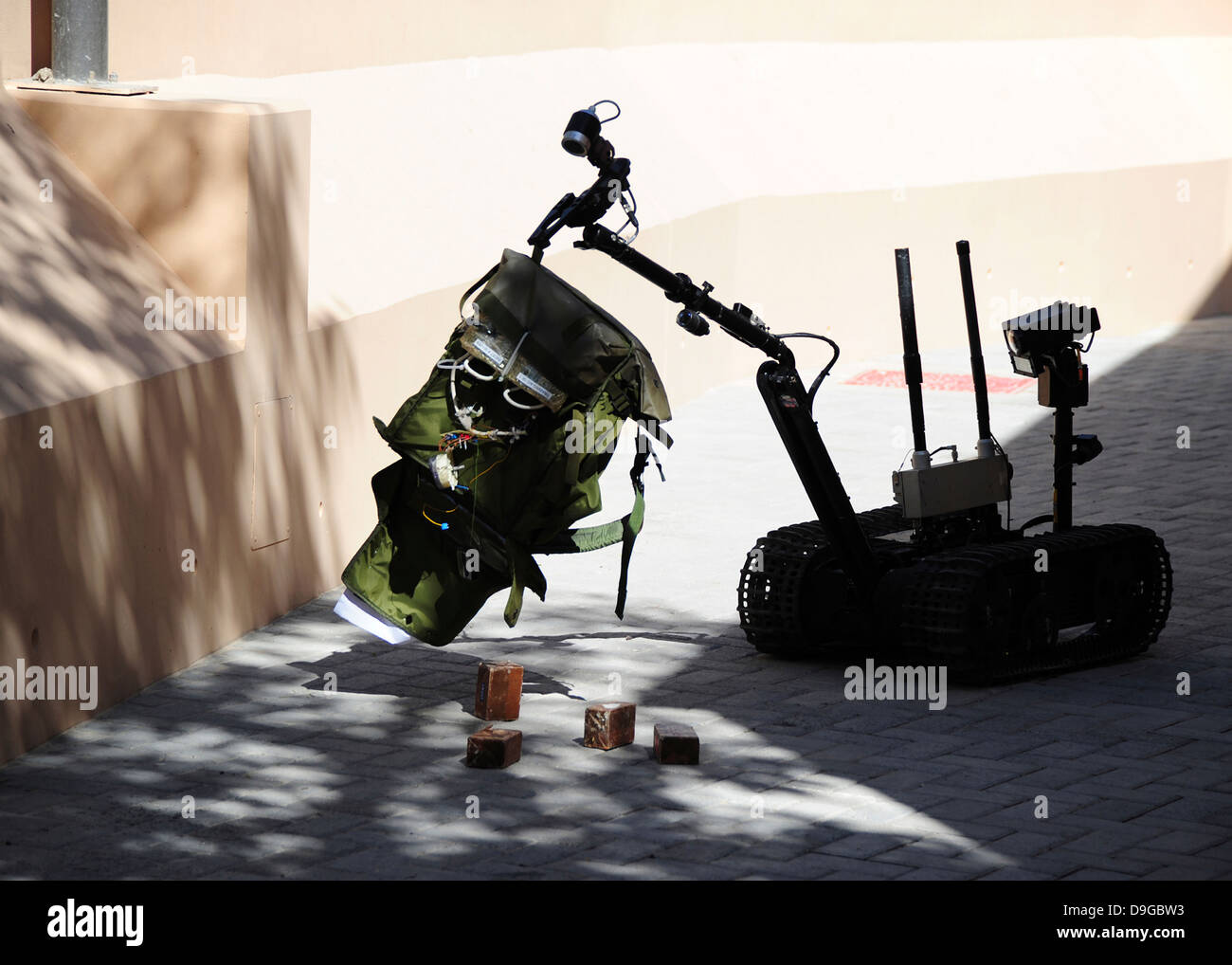 Talon remote-controlled robot investigates an improvised explosive device. Stock Photo