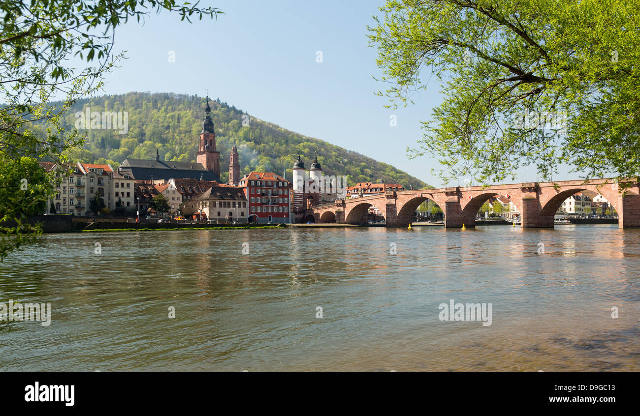 Medieval bridge leading into old town of Heidelberg Germany from riverbank of River Neckar Stock Photo