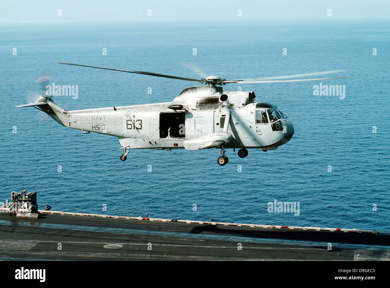 An SH-3H Sea King helicopter prepares to land on USS Saratoga. Stock Photo
