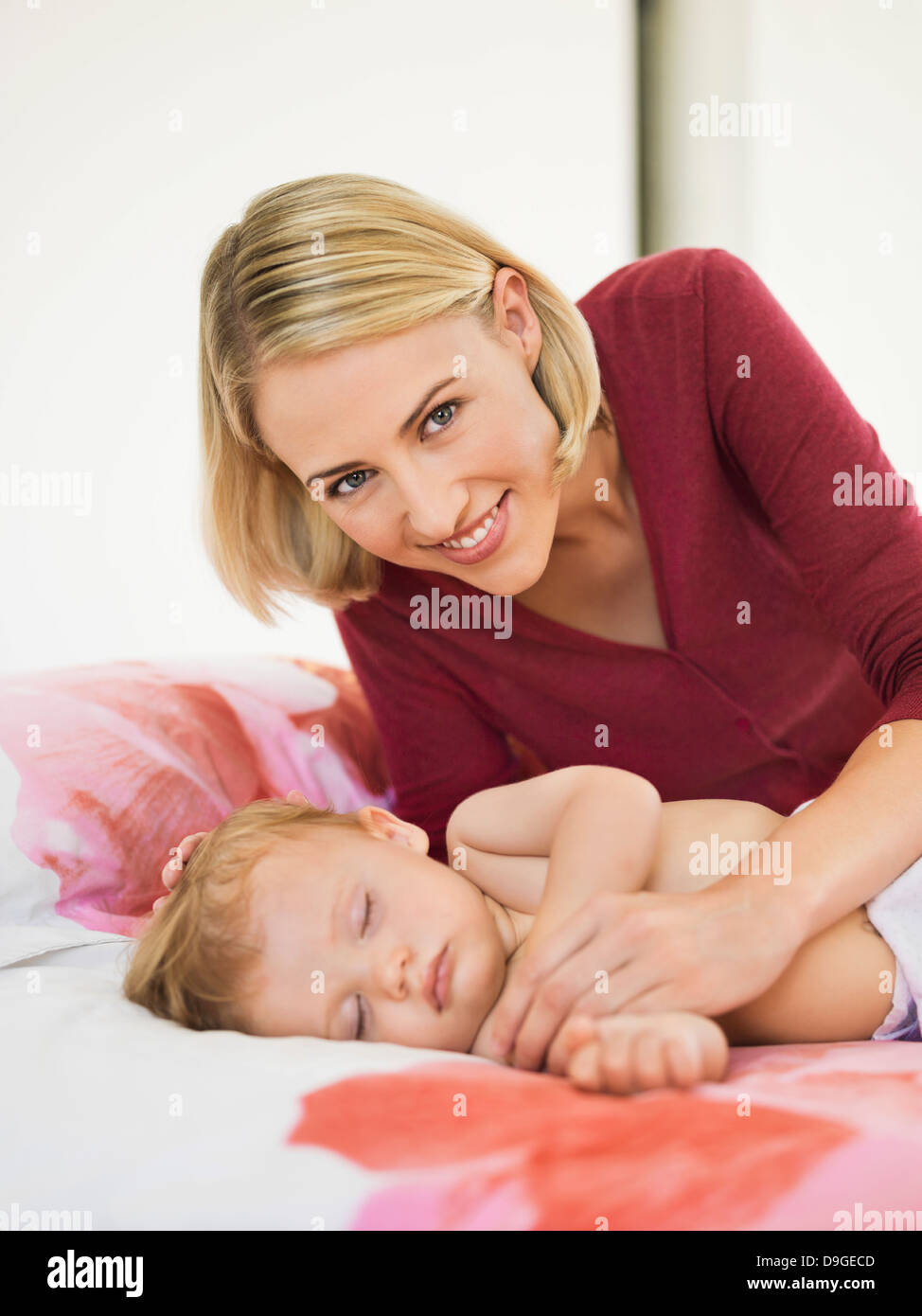 Woman Near Her Baby Sleeping On The Bed Stock Photo Alamy woman-near-her-baby-sleeping-on-the-bed-stock-photo-alamy
