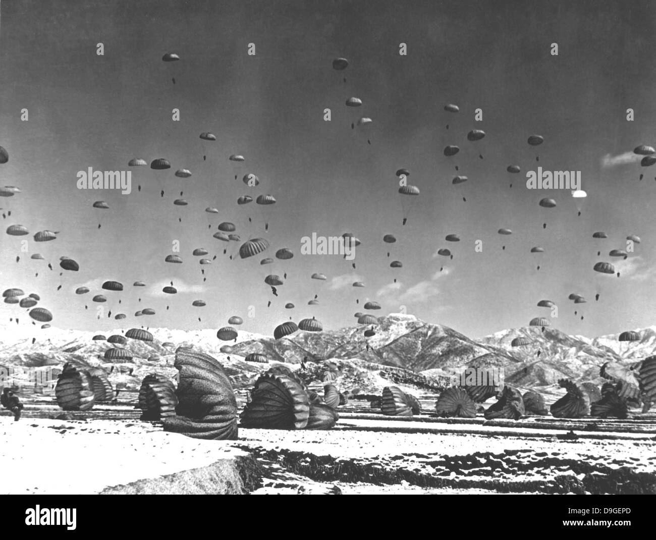 Men and equipment being parachuted to earth in an operation conducted by United Nations airborne units. Ca. 1951. Stock Photo