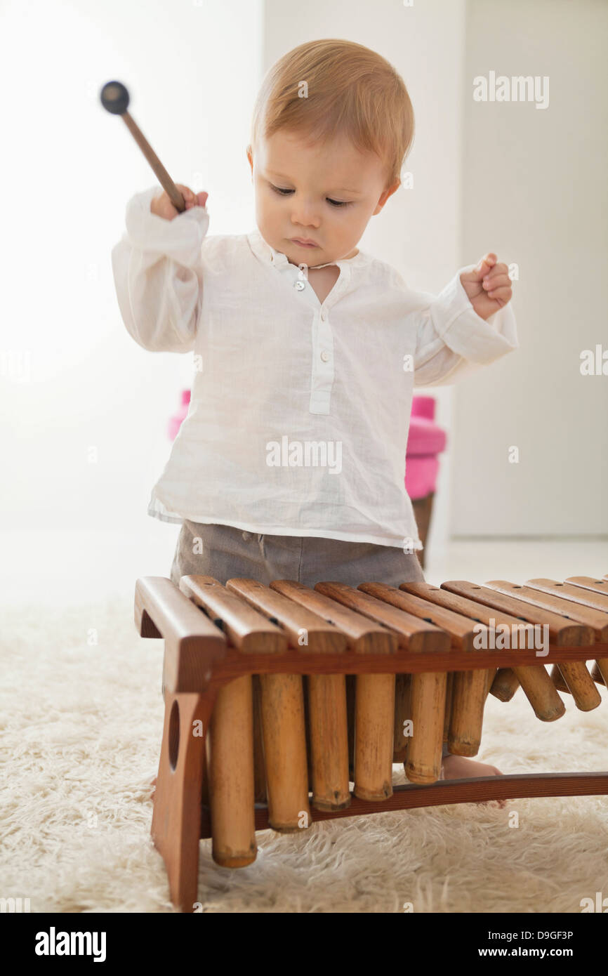 Baby boy playing a xylophone Stock Photo Alamy