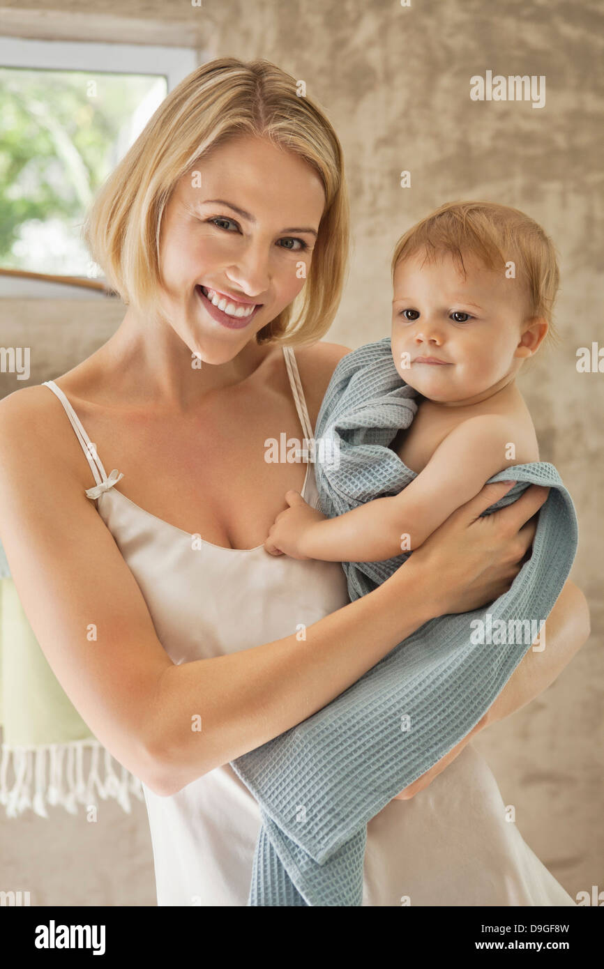 Mother holding baby towel hi-res stock photography and images - Alamy