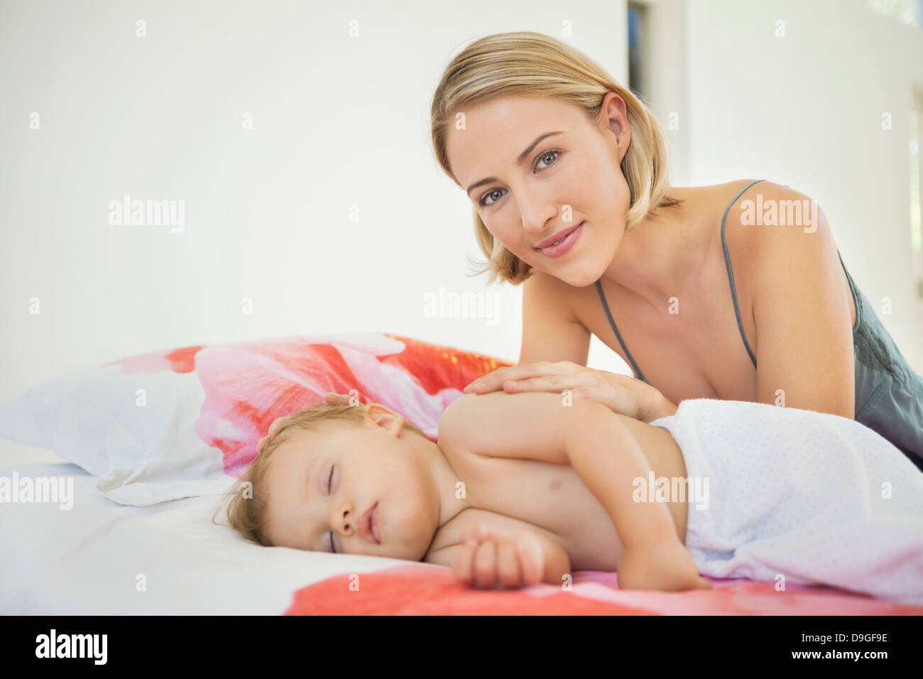 Woman Sitting Near Her Baby Sleeping On The Bed Stock Photo Alamy woman-sitting-near-her-baby-sleeping-on-the-bed-stock-photo-alamy