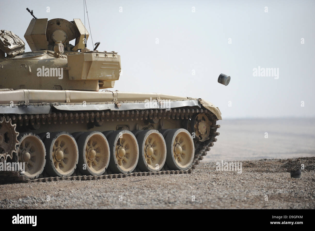 Empty casings eject from an Iraqi T-72 tank on the firing range. Stock Photo