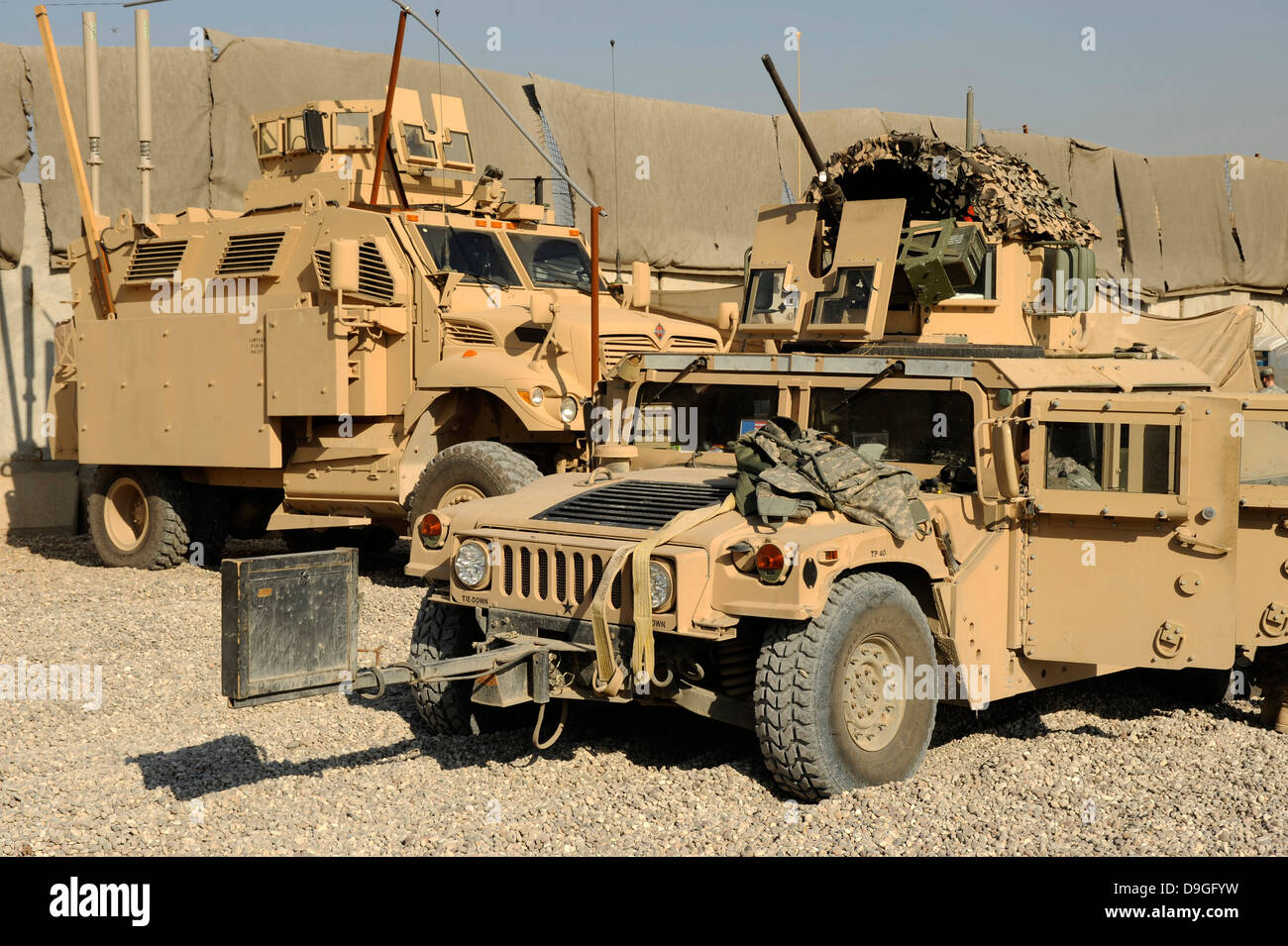 A M1114 humvee sits parked in front of a MaxxPro MRAP. Stock Photo