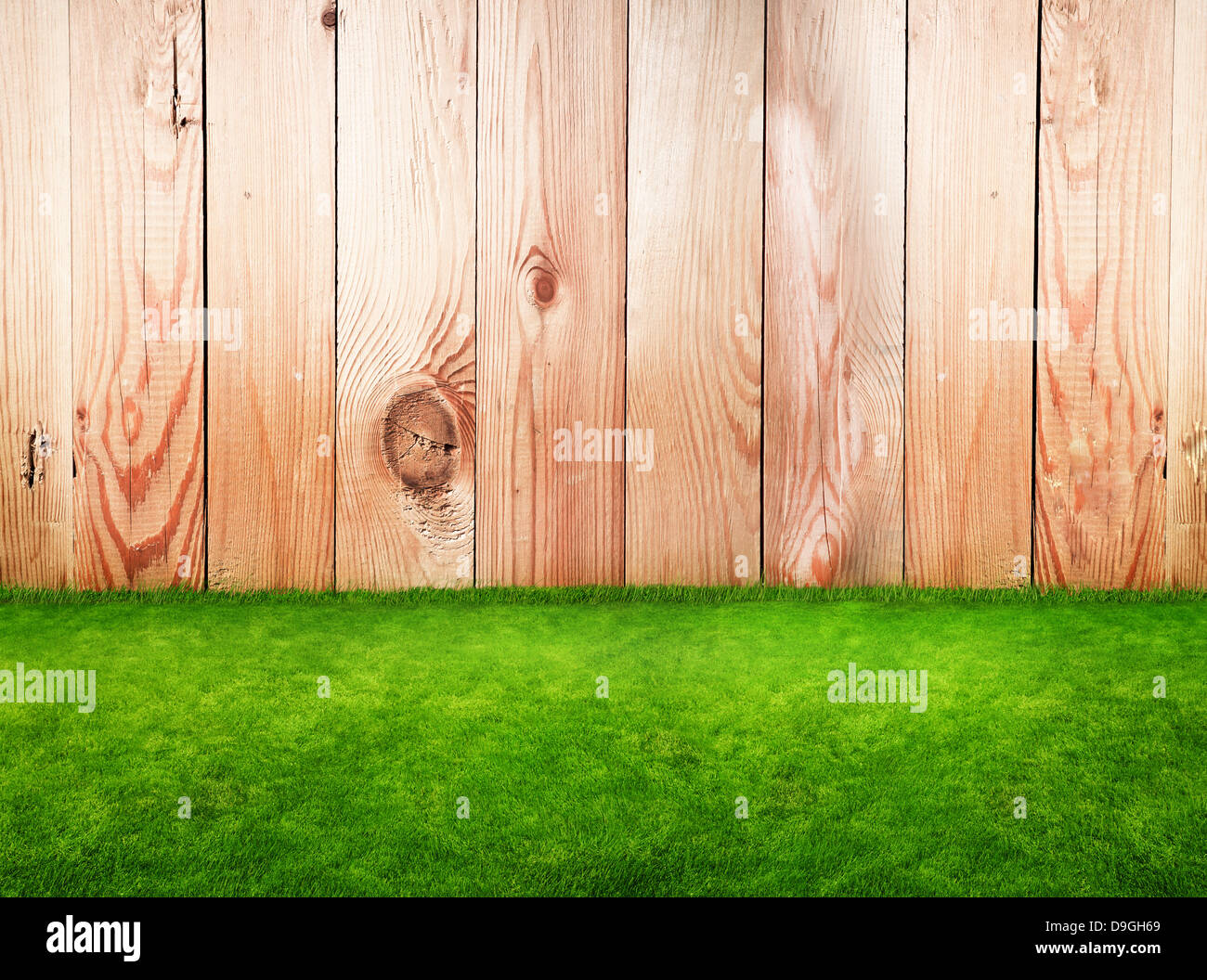 Wooden fence in a green grass Stock Photo - Alamy