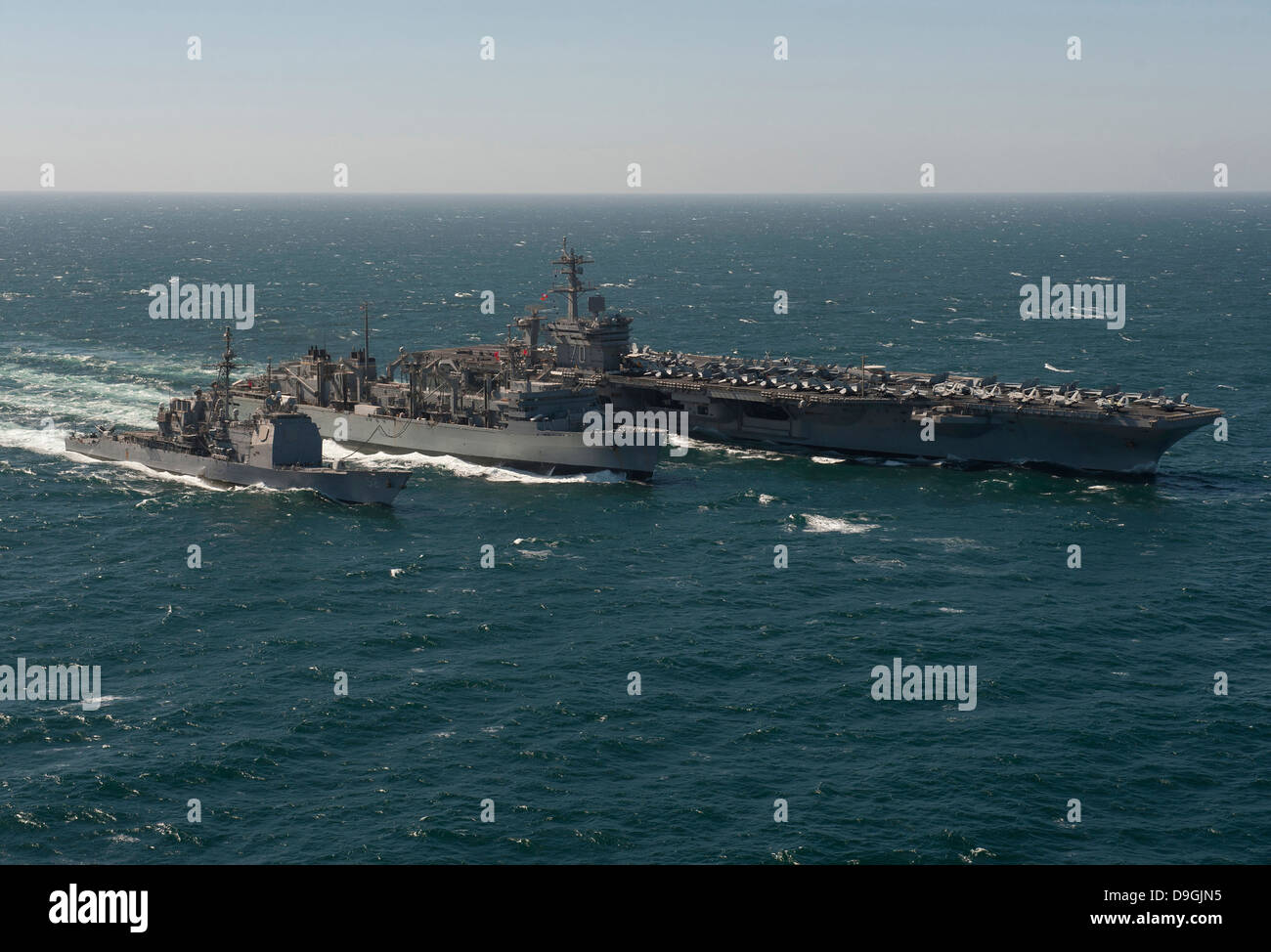 Underway replenishment at sea with U.S. Navy ships in the Arabian Gulf. Stock Photo