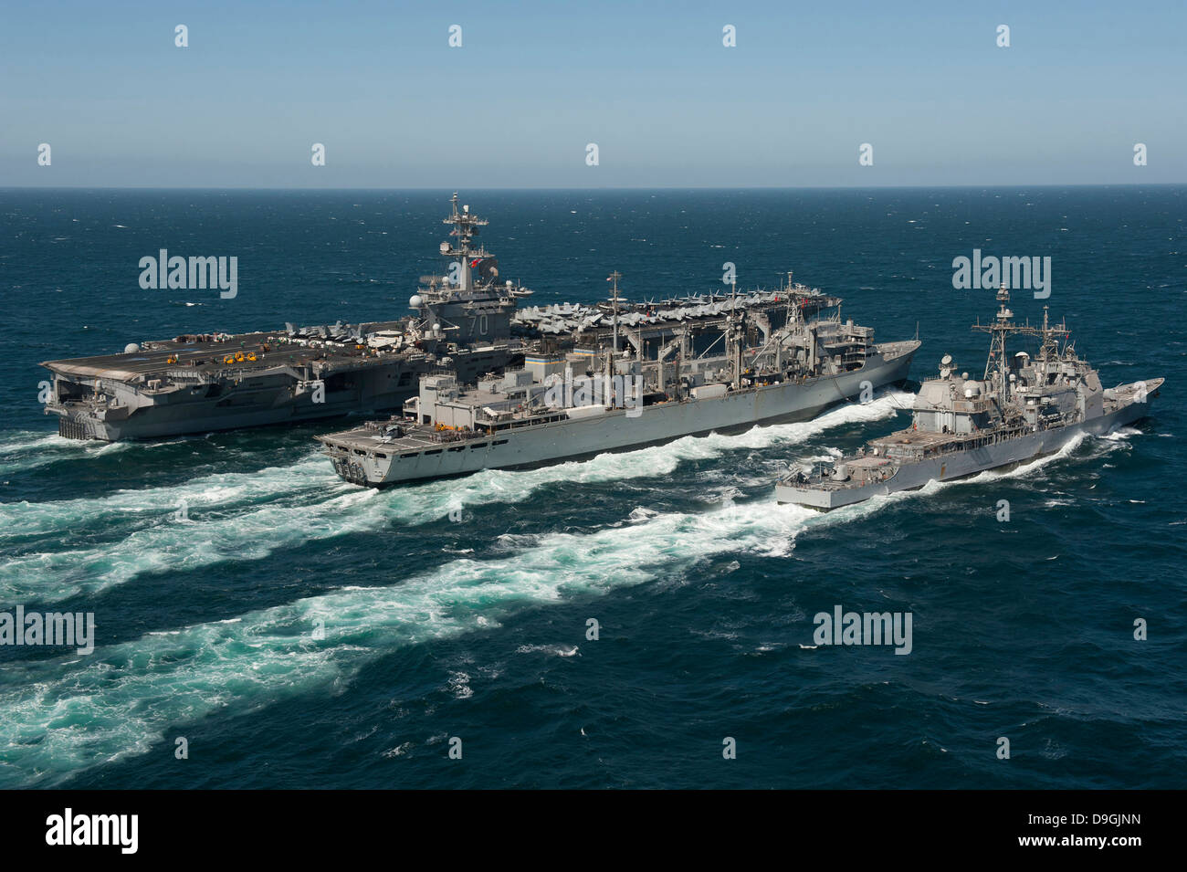 Underway replenishment at sea with U.S. Navy ships in the Arabian Gulf. Stock Photo