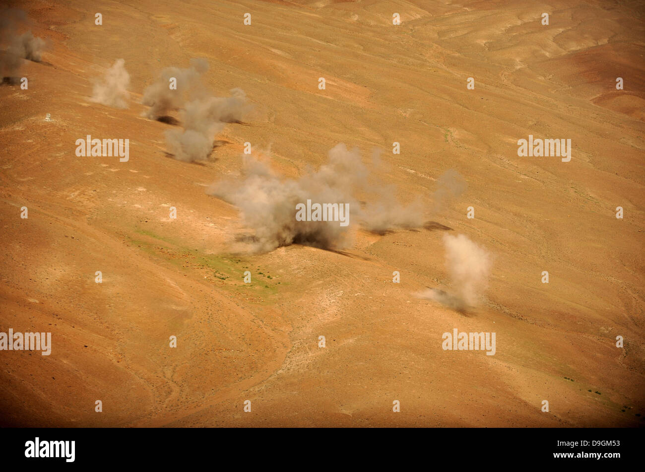 Dust rises from the impact points of KP long-guided rockets. Stock Photo